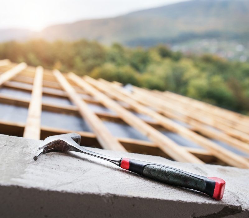 Hammer on the roof on the construction site.